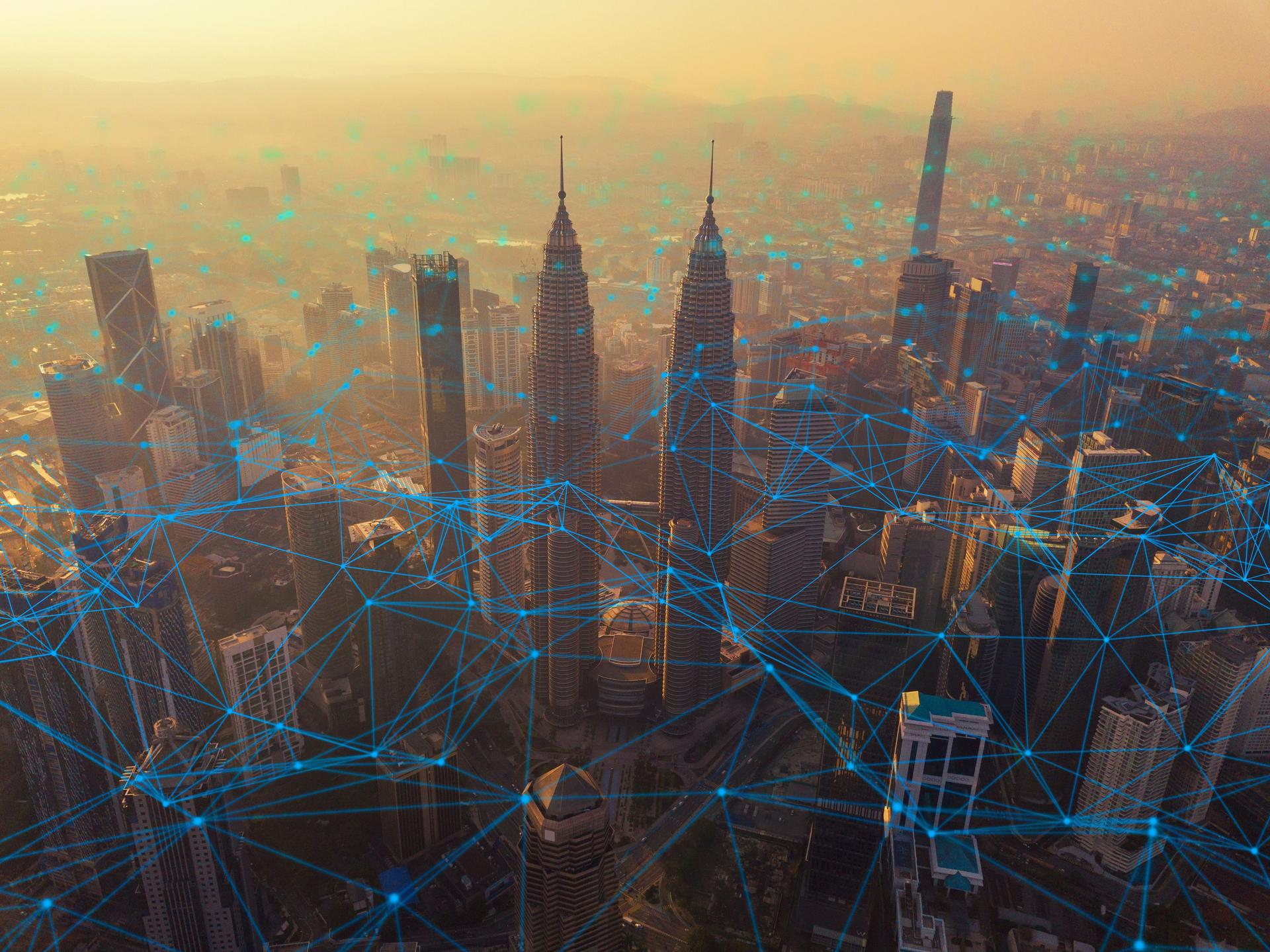Digital network connection lines of Kuala Lumpur Downtown, Malaysia. Financial district and business centers in smart city in technology concept. Skyscraper and high-rise buildings at sunset